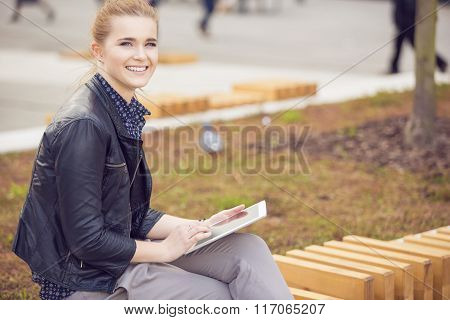 Smiling Young Womanrelaxing With Tablet On Fresh Air