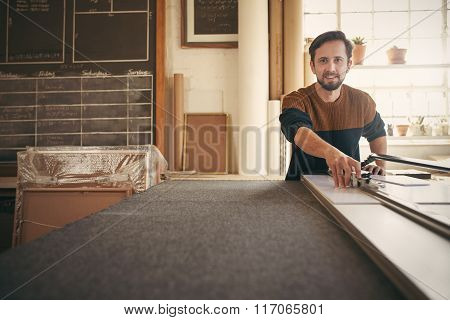 Framer looking up while using a tool on his workbench