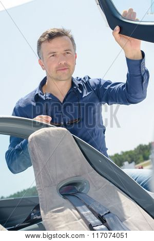 Man getting into cockpit of aircraft
