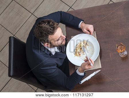 Man Eating Penne Pasta