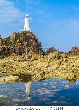 La Corbiere Lighthouse On The Rocky Coast Of Jersey Island