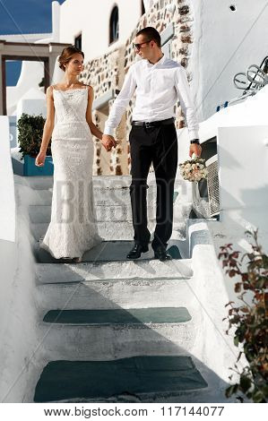 Happy Couple Bride And Groom Walking Upstairs And Having Fun Town Backrgound