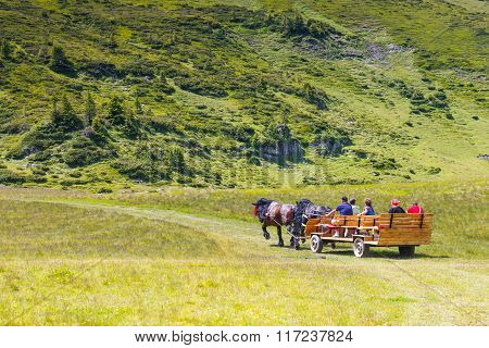 Rodna Mountains, Romania, 05 July 2015: Group Of Tourists Riding A Horse Cart In The Rodna Mountains
