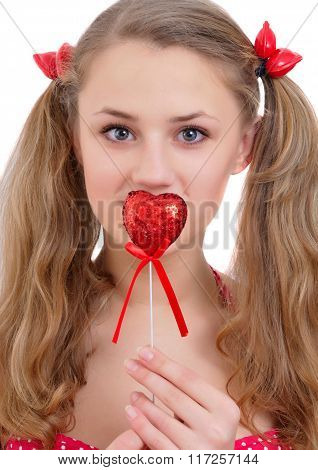 Pretty Young Girl Holding Red Hert Near Her Lips And Looking In Camera