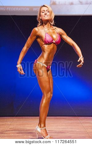 Female Figure Model Shows Her Best At Championship On Stage