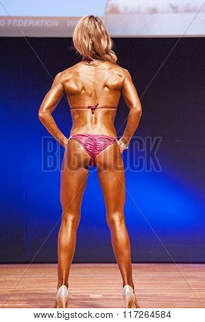 Female Figure Model Shows Her Best At Championship On Stage