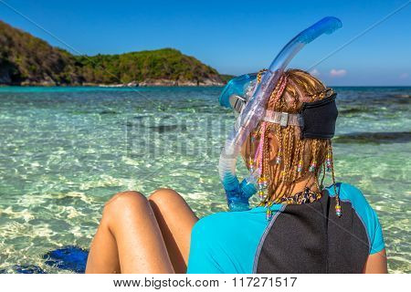 Snorkeler relaxing on tropical beach