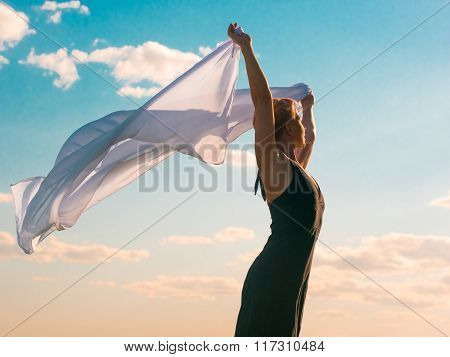 Woman with white scarf and blue sky