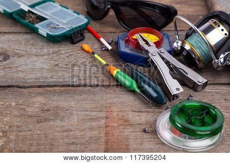 Fishing Tackles For Anglers On Wooden Background