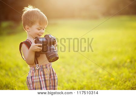 Sunny portrait of child with camera