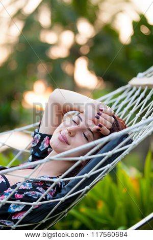 Woman Relaxing In A Hammock