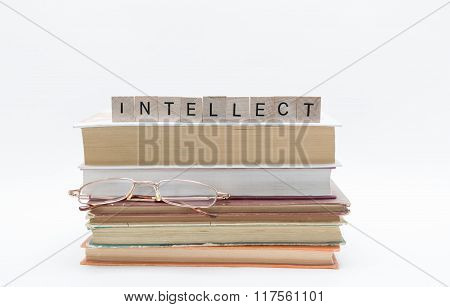 Small old stack of books with reading glasses and message word at the top