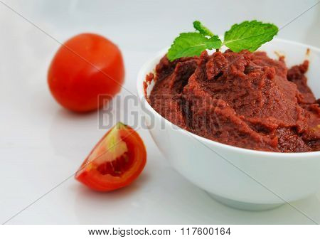 tomato paste in the bowl with mint leaf