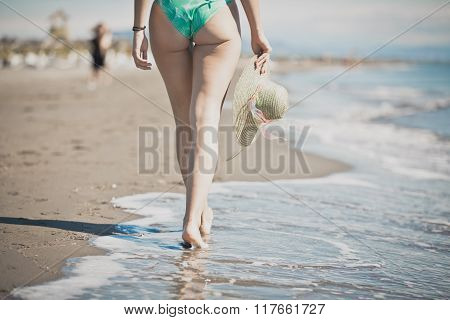 Summer beach woman enjoying summer and sun.Freedom, happiness.Fit and healthy summer body.Footsteps