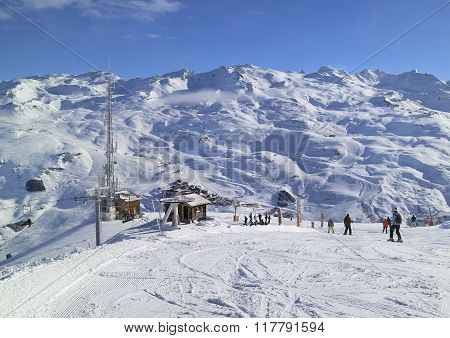 Downhill skiing and snowboarding on slopes in French Alps mountains