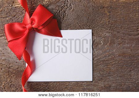 Blank present Valentine card on wooden background