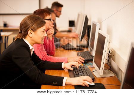 Group Of Adults Learning Computer Skills. Intergenerational Transfer Of Knowledge.