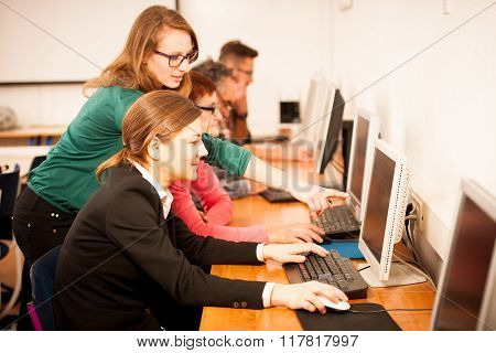 Group Of Adults Learning Computer Skills. Intergenerational Transfer Of Knowledge.