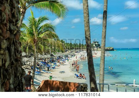 Cuban busy beautiful beach with people swimming in the ocean