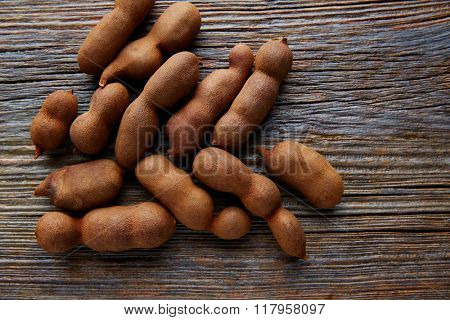 Tamarindo tamarind fruits ripe on brown wood background uses for candy