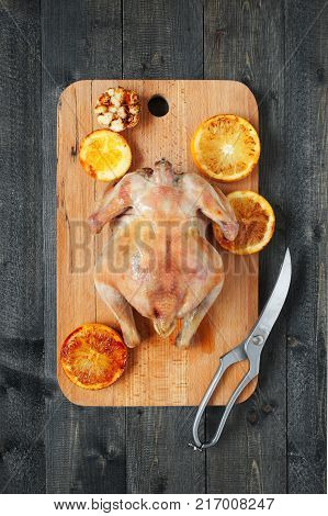 Grilled chicken with oranges and kitcen scissors