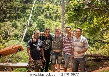 BALI, INDONESIA - DECEMBER 5, 2017: Closeup portrait of group of asian balinese indonesian men in the jungle of Bali, Indonesia. Handsome asian young guys.