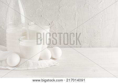 White background with milk and eggs, kitchen table