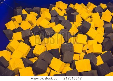Multicolored foam cubes on the playground in the trampoline center.