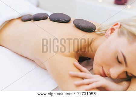 attractive young woman in bathrobe relaxing at spa