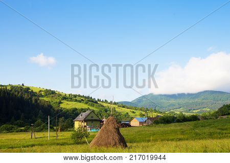 Haystack summer in the beautiful village Ukrainian Carpathians