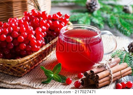 Hot tea viburnum. Tea viburnum in a glass cup on a table