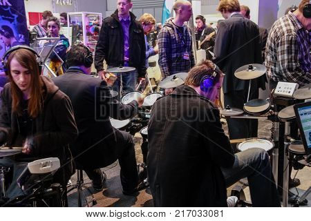 HANNOVER, GERMANY - MARCH 3, 2010: Amateur drummers play on Roland drums set in V-Drums Fun Park area at CeBIT trade show in Hannover, Germany on March 3, 2010.