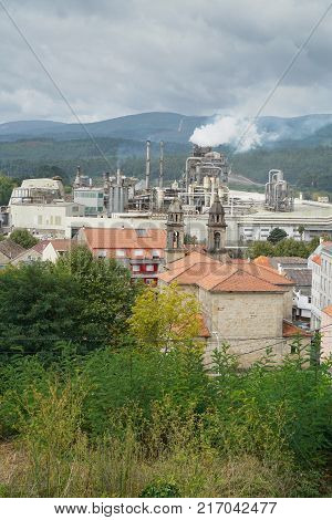 PONTECESURES, SPAIN - SEPTEMBER 10, 2017: Cityscape of Pontecesures with old church and large factory on the Camino de Santiago trail on September 10, 2017, in Galicia, Spain