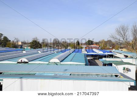 Covered Market In The City. Rows Of Sales Outlets. View From The Bridge To The City Market.