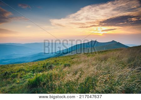 Summer Mountain Landscape At Sunrise With Grass And Blue Sky