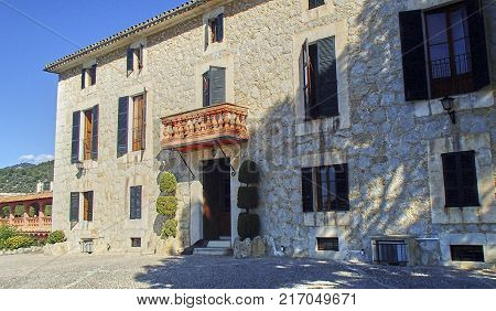 Typical finca on the land of the Spanish holiday island of Majorca from sandstone and with blue shutters