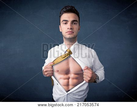 Businessman tearing off his shirt and showing mucular body concept on background