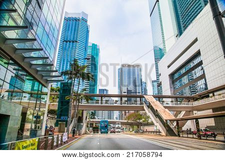 HONG KONG - APR 3, 2016:  Street scene typically Asian with high buildings along both sides and plethora neon signs in Hong Kong on Apr 3, 2016, Hong Kong.