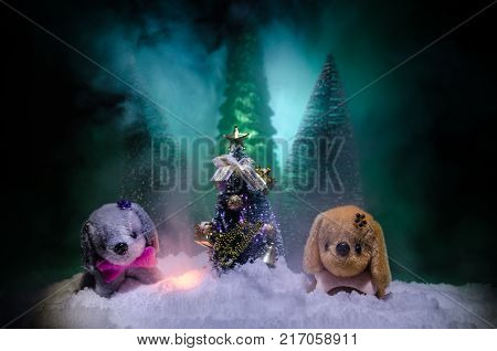 Toy Dog - A Symbol Of The New Year Under The Snow Against The Background Of Fir Branches. Toy's Dog 