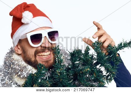 portrait, man in glasses, emotions, tinsel, artificial Christmas tree, new year.