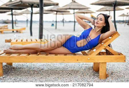 Beautiful young girl in a sexy blue swimsuit