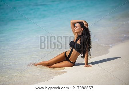 Beautiful young girl in a sexy bikini on the beach