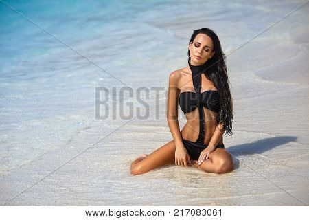 Beautiful young girl in a sexy bikini on the beach
