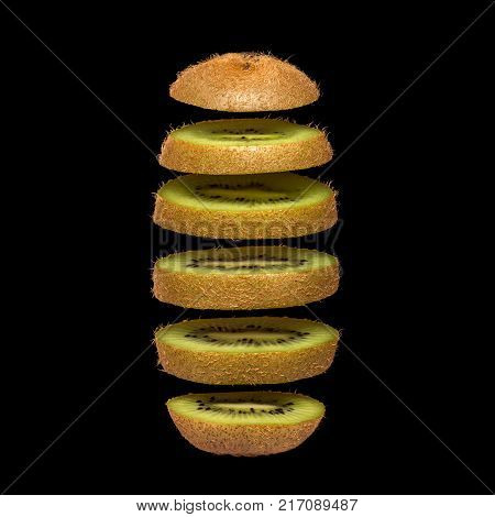 Creative concept with flying kiwi. Sliced kiwi isolated on black background. Levity fruit floating in the air