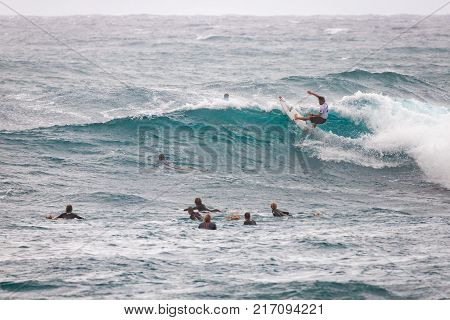 SUNSET BEACH HAWAII USA - DECEMBER 2, 2017: Competitive surfers at the 2017 Vans World Cup of Surfing competition at Sunset Beach on Oahu's scenic North Shore. This is the second of three surfing competitions and Conner Coffin
