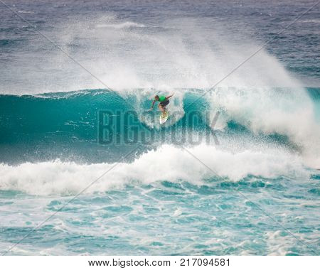 SUNSET BEACH HAWAII USA - DECEMBER 2, 2017: Competitive surfer at the 2017 Vans World Cup of Surfing competition at Sunset Beach on Oahu's scenic North Shore. This is the second of three surfing competitions and Conner Coffin took first place.