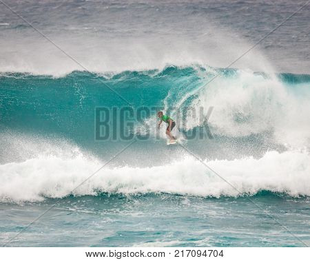 SUNSET BEACH HAWAII USA - DECEMBER 2, 2017: Competitive surfer at the 2017 Vans World Cup of Surfing competition at Sunset Beach on Oahu's scenic North Shore. This is the second of three surfing competitions and Conner Coffin took first place.