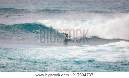 SUNSET BEACH HAWAII USA - DECEMBER 2, 2017: Competitive surfer at the 2017 Vans World Cup of Surfing competition at Sunset Beach on Oahu's scenic North Shore. This is the second of three surfing competitions and Conner Coffin took first place.