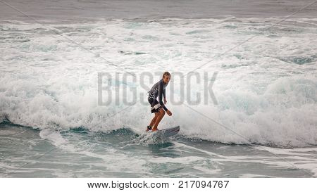 SUNSET BEACH HAWAII USA - DECEMBER 2: Competitive surfer at the 2017 Vans World Cup of Surfing competition at Sunset Beach on Oahu's scenic North Shore. This is the second of three surfing competitions and Conner Coffin took first place.