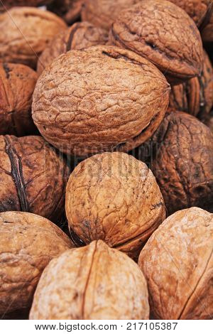 Walnut texture. Brown big walnuts as background. walnut nuts pattern close up photo. Walnuts.